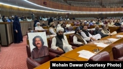 A fellow member of Pakistan's National Assembly put a photo of Ali Wazir on his chair in protest in March 2022.