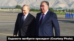 Tajik President Emomali Rahmon (right) greets his Russian counterpart, Vladimir Putin, in Dushanbe on June 28. 