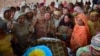 Women mourn around the body of a man who died when the roof of his house collapsed due to heavy rains on the outskirts of Quetta on July 5.