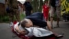 Viktor Kolesnik weeps as he holds the body of his wife, Natalia Kolesnik, who was killed during a missile strike in their neighborhood in Kharkiv on July 7.<br />
<br />
The regional governor, Oleh Synyehubov, said three people were killed and another five were wounded as he pleaded with residents to stay off the streets.