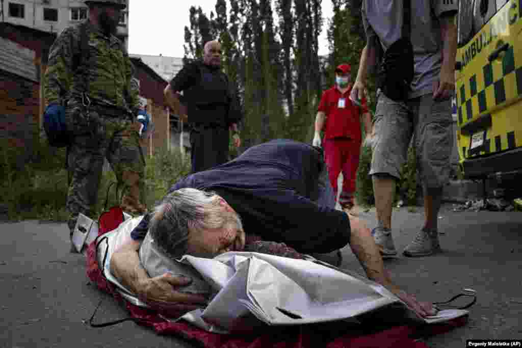 Viktor Kolesnik weeps as he holds the body of his wife, Natalia Kolesnik, who was killed during a missile strike in their neighborhood in Kharkiv on July 7. The regional governor, Oleh Synyehubov, said three people were killed and another five were wounded as he pleaded with residents to stay off the streets.