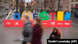 People walk past an installation that reads "Zamestim" (We Will Replace), assembled from the first letters of brands that left Russia in response to its invasion of Ukraine, in St. Petersburg in April.