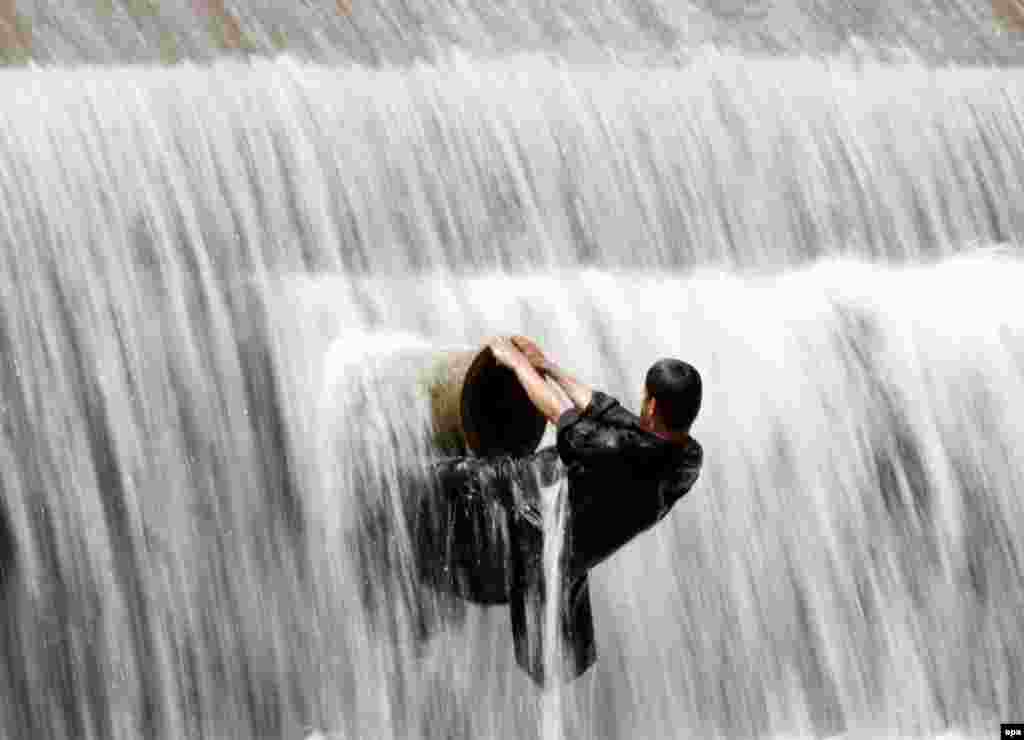 A Pakistani boy cools off in a stream on the outskirts of Islamabad. Officials say more than 500 people have died from a three-day heat wave in southern Pakistan and a state of emergency was declared in hospitals. (epa/Sohail Shahzad)