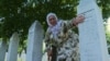 GRAB Bosnian Woman Buries Her Son's Skull At Srebrenica Memorial