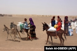 Families receive flour rations and other basic food supplies in southern Yemen, where rising food costs are contributing to a deepening famine.