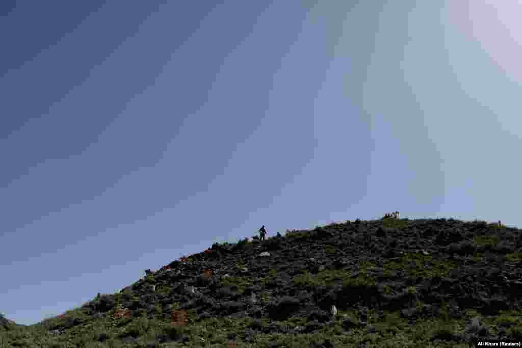 A deminer surveys the landscape from his vantage point in Kabul Province.&nbsp;Though hundreds of devices have been detonated, tens of thousands of square miles have yet to be cleared.