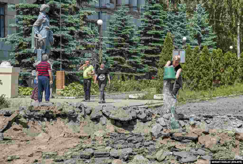 A woman cleans up debris at the academy.