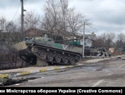 A Russian BMD fighting vehicle stuck on a chunk of concrete after a fierce firefight in Hostomel on March 4.