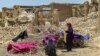 Afghan quake survivors dry clothes on some old branches in the Bermal district of Paktika Province on June 23. (file photo)