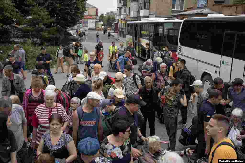 Civilians gather at the train station in Pokrovsk to be evacuated on June 25. The United Nations says at least 12 million people have fled their homes since Russia&#39;s attack began in February.&nbsp;