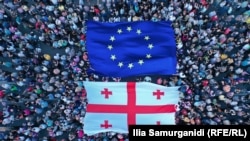 Supporters hold up EU and Georgian flags as part of a rally for European integration, in Tbilisi in July 2022.