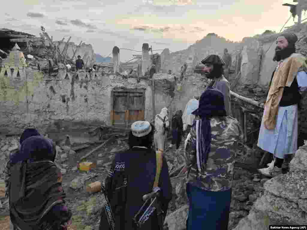 Afghans look at destruction caused by a major earthquake in the province of Paktika, in southeastern Afghanistan, on June 22. At least 1,150 people were killed. The death toll makes the earthquake, which was measured at a magnitude of 6.1, Afghanistan&#39;s&nbsp;worst natural disaster&nbsp;in two decades.