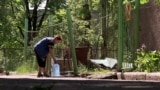 Woman filling a bottle with water in the eastern Ukrainian city of Avdiyivka