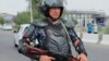 An Uzbek law enforcement officer guards on a street in Nukus on July 3. 