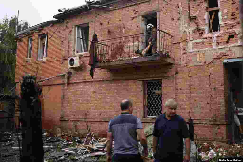 Rescuers extract a body from a residential building damaged by a Russian military strike in Kharkiv on July 11.