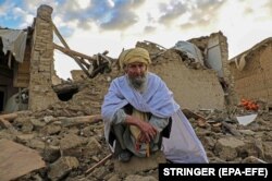 A man affected by the earthquake waits for relief in Gayan in Paktika Province on June 23.