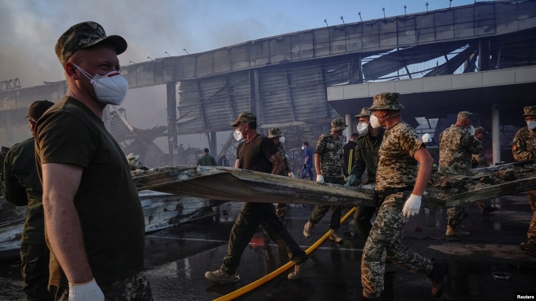 Rescue services work at the site of a shopping mall hit by a Russian missile strike in Kremenchuk on June 27.