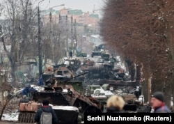 A column of destroyed vehicles on a street in Bucha on March 1