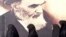 Iranian women walk past a poster of the late Supreme Leader Ayatollah Ruhollah Khomeini, who died in 1989. (file photo)