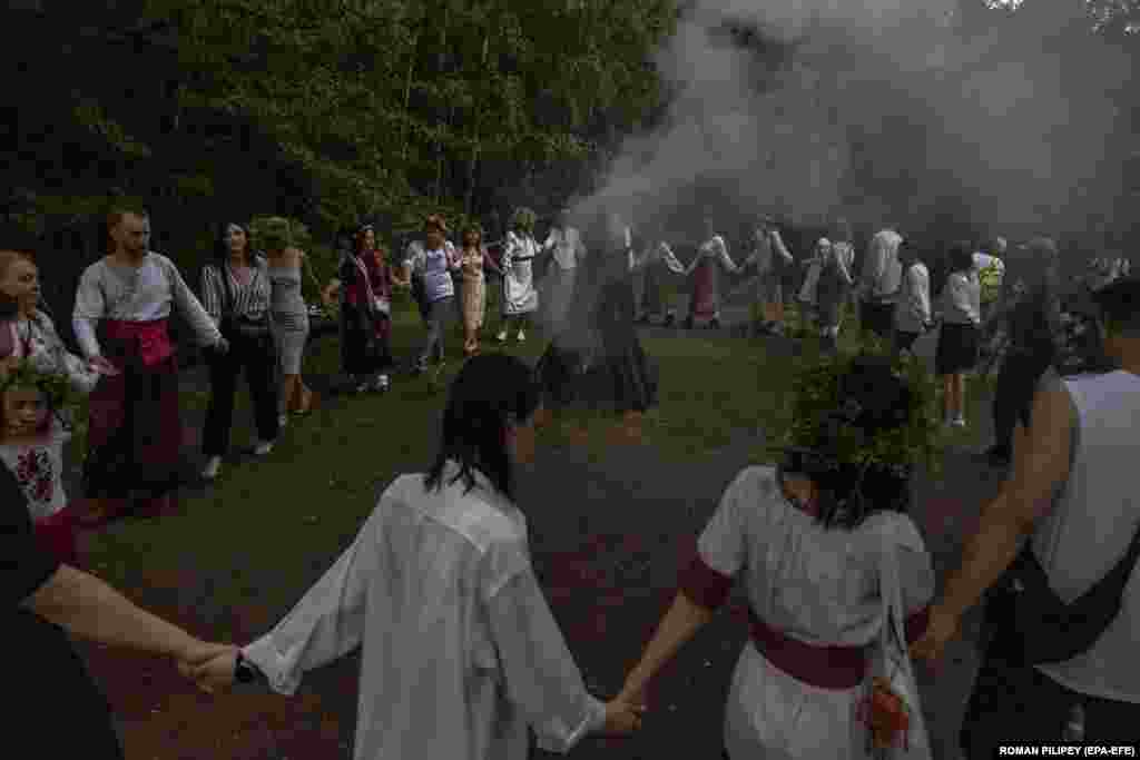 Ukrainians dance around a bonfire while celebrating the traditional pagan holiday of Ivana Kupala in Kyiv on July 6. Ivana Kupala is usually celebrated on the shortest night of the year, marking the beginning of summer. People sing and dance around bonfires, play games, and perform traditional rituals.