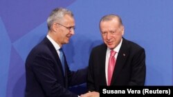 Secretarul general al NATO, Jens Stoltenberg (stânga), și președintele Turciei, Recep Tayyip Erdogan (dreapta), în timpul summitului de la Madrid, 29 iunie 2022. 