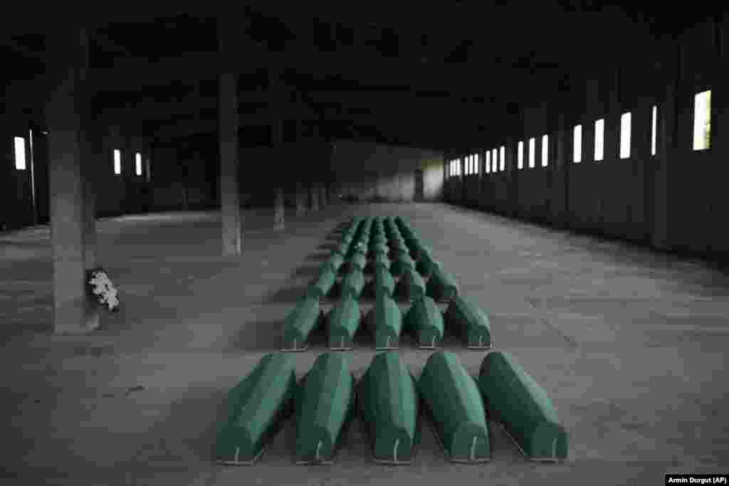 Coffins containing the remains of 50 newly identified victims of the Srebrenica genocide are lined up inside a hall in Potocari as Bosnia-Herzegovina marked the 27th anniversary of the killings of thousands of Bosnian Muslim men and boys by Bosnian Serbian forces during the Bosnian war.