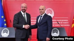 European Council President Charles Michel (left) shakes hands with Macedonian Prime Minister Dimitar Kovachevski at a joint press conference in Skopje on July 5.