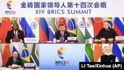 Chinese President Xi Jinping (center) hosts the 14th BRICS Summit via video link from Beijing on June 23, as Russian President Vladimir Putin (bottom left) looks on.
