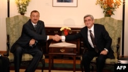 Armenian President Serzh Sarkisian (right) shakes hands with his Azerbaijani counterpart, Ilham Aliyev, during a meeting in Chisinau in October 2009.