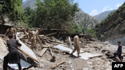 Pakistani Army personnel help villagers after their house was destroyed by flash flooding in Ursoon village in Chitral earlier this month. At least 55 people have been killed since the beginning of July due to flooding, according to Pakistan's National Disaster Management Authority.