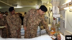 A Pakistani general visits a victim of cross-border Indian firing at the line of control in the disputed Himalayan region of Kashmir.