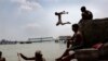 Indian boys cool off by diving into the River Ganges in Calcutta. (epa/Piyal Adhikary)