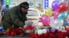 A man places a toy at the site, where a woman suspected of killing a child was detained in Moscow on February 29. Despite the shocking nature of the story, none of Russia's main TV channels covered it. 