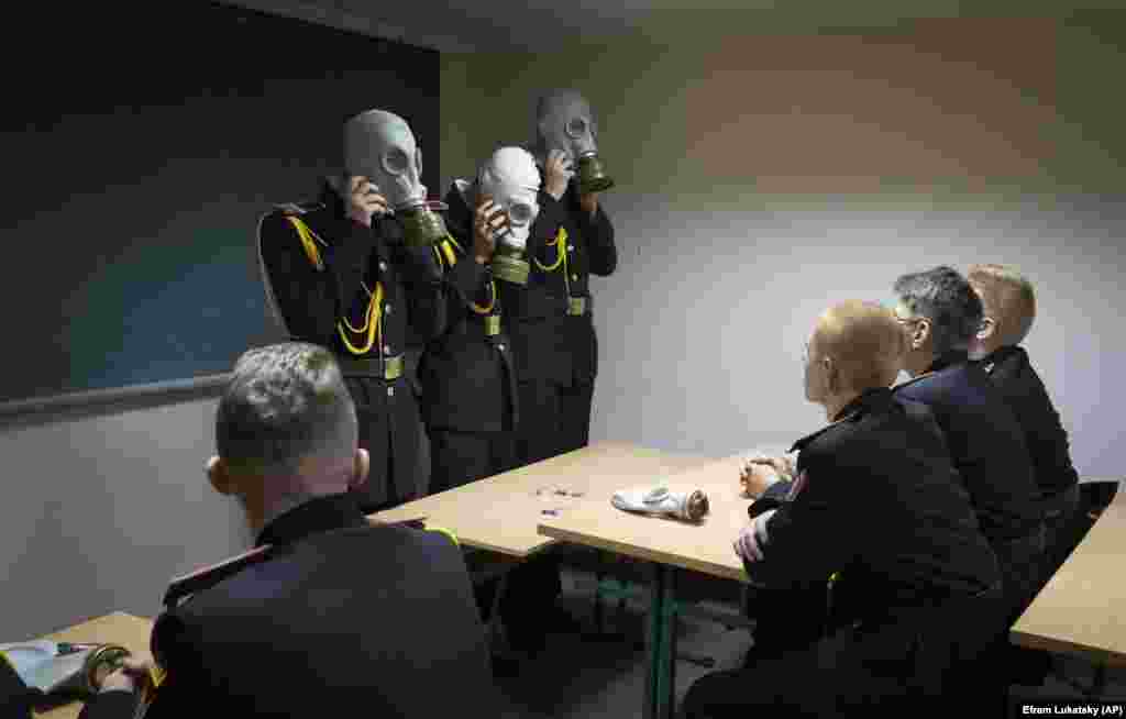 Ukrainian cadets practice an emergency situation during a lesson in a bomb shelter on the first day of school at a cadet lyceum in Kyiv.