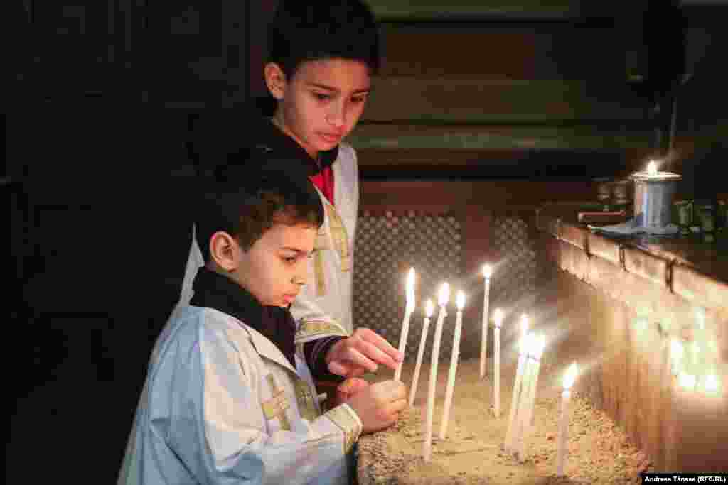 Doi copii armeni aprind lumânări înaintea ceremonialului religios oficiat în Joia Mare , intitulat &bdquo;Spălarea picioarelor&rdquo;, în Catedrala Apostolică Armeană Sfinţii Arhangheli Mihail şi Gavriil (1911 &ndash; 1915) din Bucureşti.&nbsp;