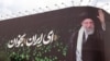 This picture shows a billboard bearing the portrait of Iranian supreme leader Ayatollah Ali Khamenei and a quote reads in Persian 'Sing Oh Iran' at the Enqelab Square in Tehran on July 9.