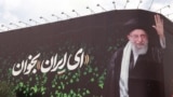 This picture shows a billboard bearing the portrait of Iranian supreme leader Ayatollah Ali Khamenei and a quote reads in Persian 'Sing Oh Iran' at the Enqelab Square in Tehran on July 9.