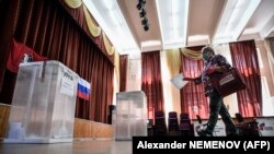 A woman casts her ballot during early voting at a polling station in Moscow on June 29. 