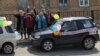 Activists in cars decorated with balloons and "Kamchatka To Moscow" signs stopped en route to distribute anti-Putin and left-wing political pamphlets.