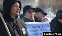 Олег Аникин с плакатом на акции протеста