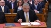 Hungarian Prime Minister Viktor Orbán signs the documents in parliament in Budapest declaring him prime minister for the fourth consecutive time on May 16.