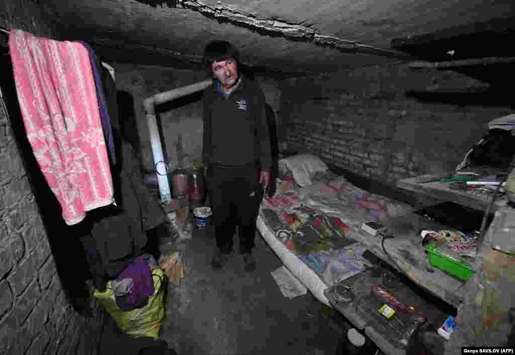 Local resident Mykola, 60, stands in his cellar, which he used as a shelter during the Russian invasion, and where he now lives after his house was destroyed, in the village of Kozarovychi, north of Kyiv.
