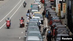 Drivers line up to buy petrol at a fuel station in Colombo on May 16. Sri Lanka has already defaulted on external debt amid turmoil and protests over the government's mismanagement of the economy.