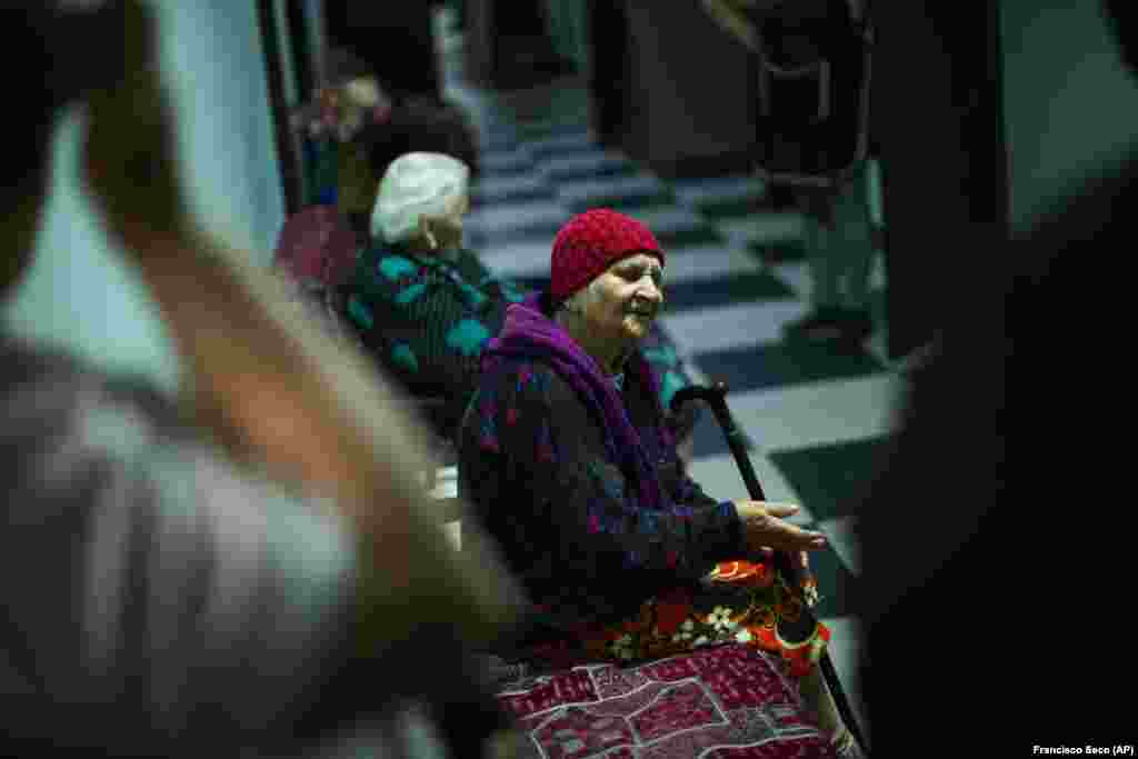 Anna Loboda, 93, a former choir member, sings in St. Michael&#39;s Monastery, where she now lives. Loboda, who has no family, was saved by a neighbor who took her from their village before it was captured by Russian troops.