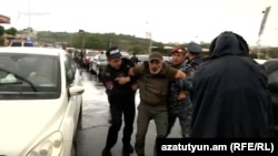 An opposition protester is arrested in Yerevan on May 16.