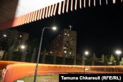 An illuminated cross against the night sky.