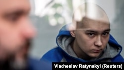 Vadim Shishimarin, 21, sits inside a defendants' cage during a court hearing in Kyiv on May 13.