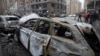 Rescue workers and investigators attend the aftermath of a Russian strike on Kyiv on December 20. 