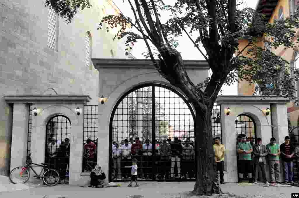 Men pray at a mosque in Pristina following the ceremony marking the end of Ramadan.