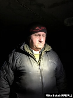 Serhiy Averko stands in the bomb-shelter basement where he and his wife, Alla, huddled with soldiers amid a barrage of Grad rockets.